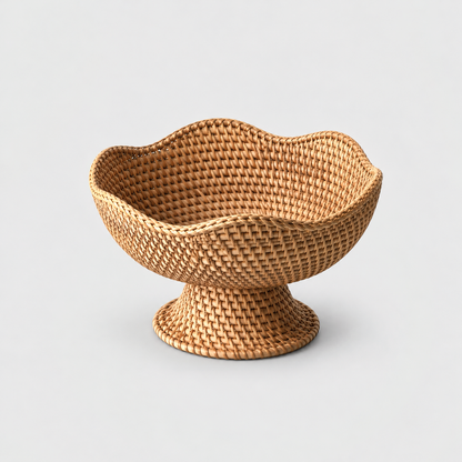 Woven rattan fruit bowl with a softly waved rim and a flared pedestal foot on a light gray background, the same design in the Small, Medium and Large size