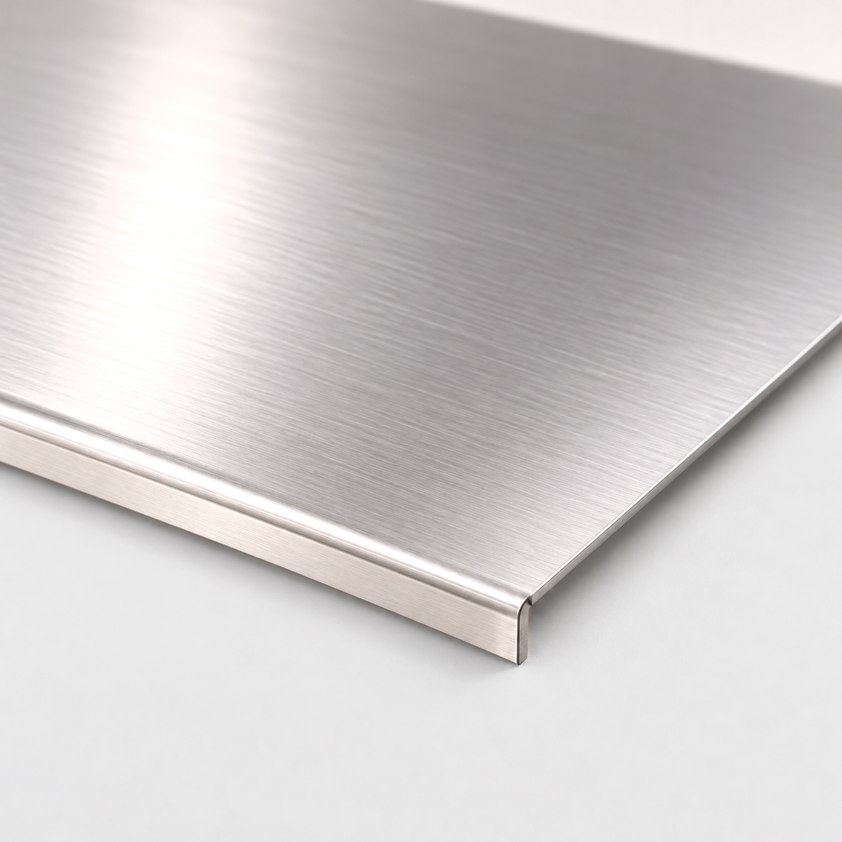 Close-up of the corner and the folded lip of a brushed stainless steel chopping board