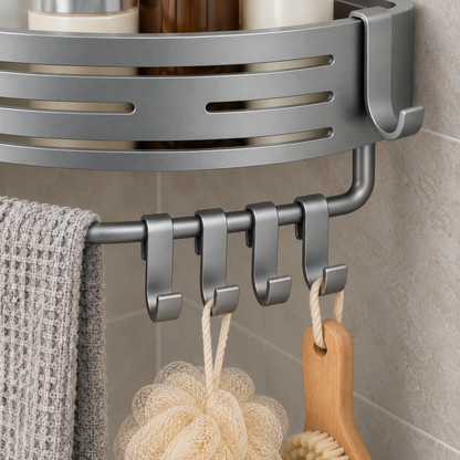 Close view of the gray towel bar under the corner basket, with a waffle washcloth over it and a loofah and a back brush hanging from its sliding hooks