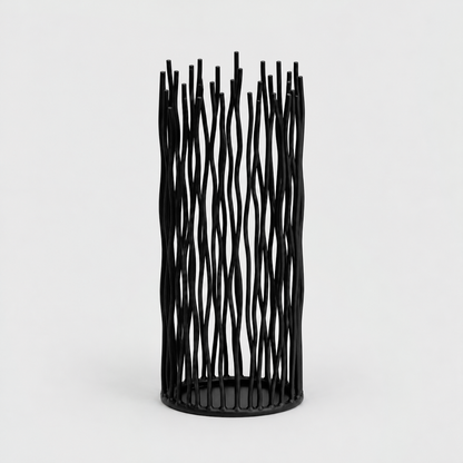 Medium black iron pillar candle holder with wavy vertical rods on a light gray background