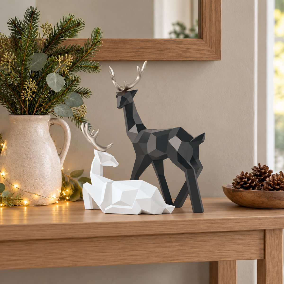 White lying reindeer resting in front of a black standing reindeer and looking up at it, on an oak hall console beside a jug of fir stems