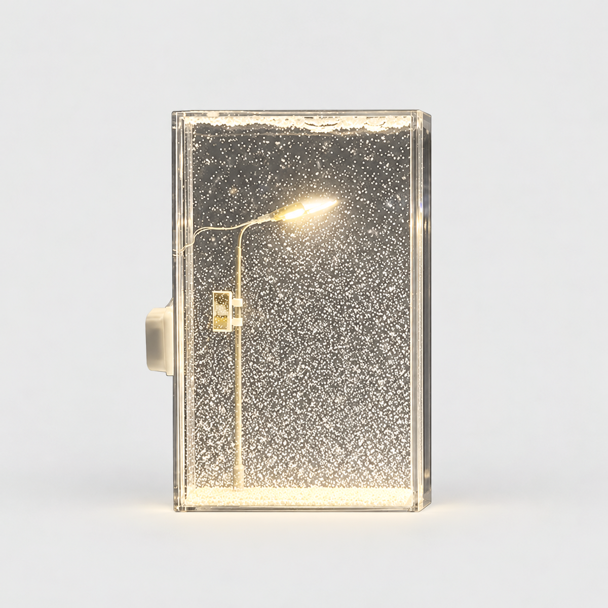 Clear snow scene night light with a miniature street lamp glowing warm white over drifting white snow