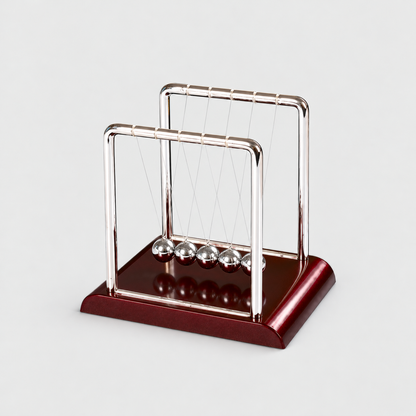 Newton's cradle desk ornament with two polished steel frames, five steel balls and a glossy wine red base on a light gray background