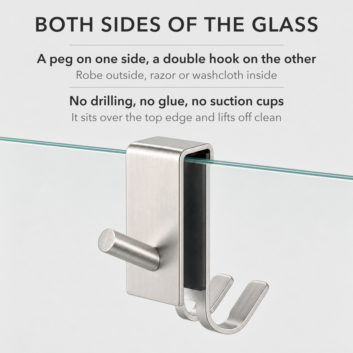 Silver shower door hook on glass with a round peg on one side and a double hook on the other, with text on no-drill fitting
