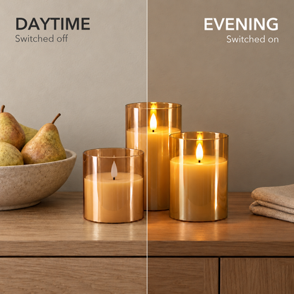Amber glass flameless candles shown switched off in daylight and lit in the evening on an oak sideboard
