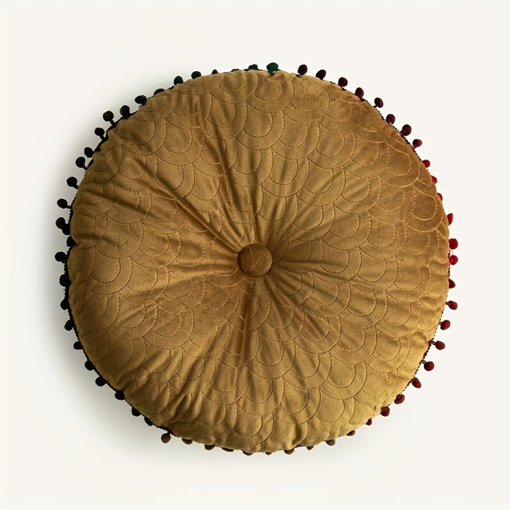 Mustard round velvet cushion seen from above