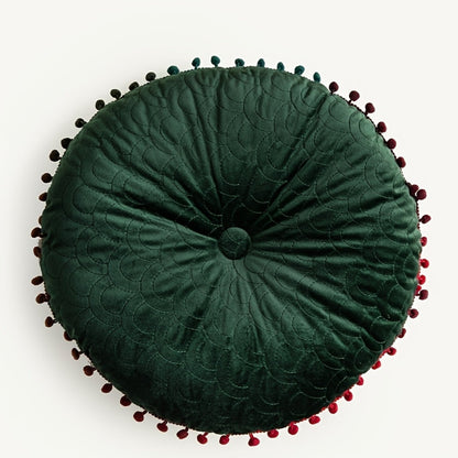 Green round velvet cushion seen from above