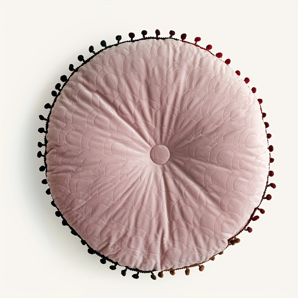 Pink round velvet cushion seen from above