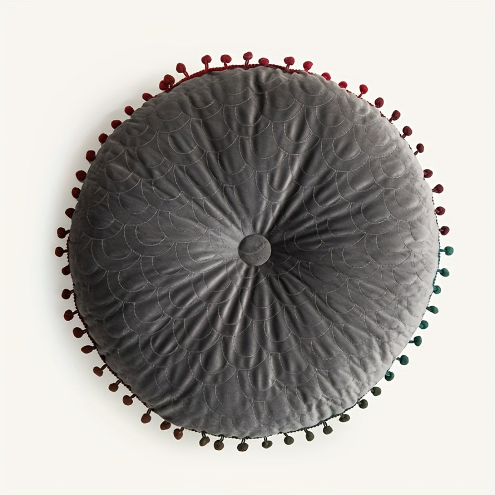 Gray round velvet cushion seen from above