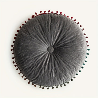 Gray round velvet cushion seen from above