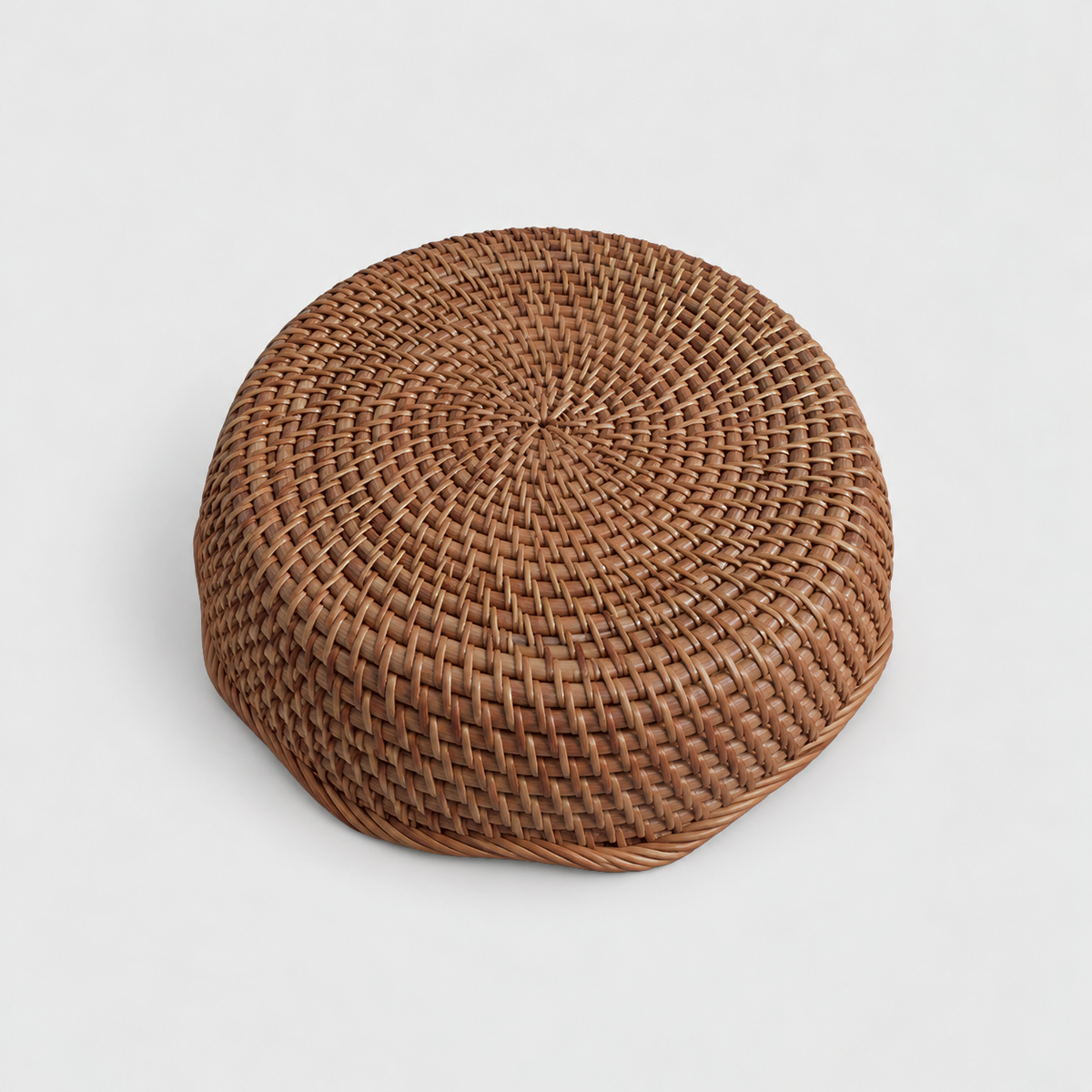 Underside of the rattan basket showing its flat round base woven in a spiral