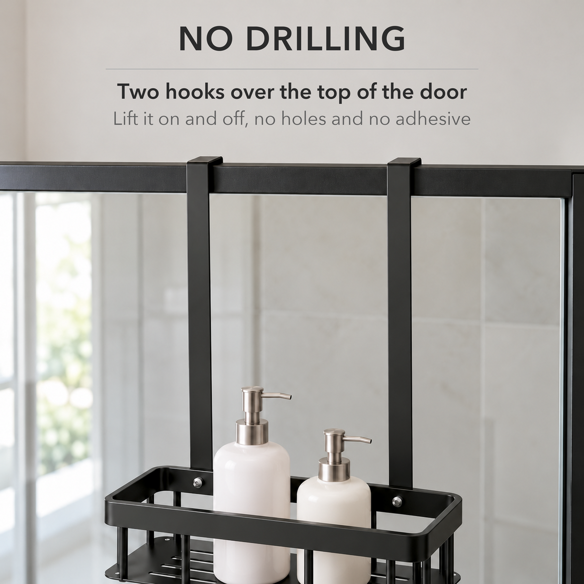 Two flat black hooks over the top rail of a glass shower door, with text saying the caddy hangs on with no drilling