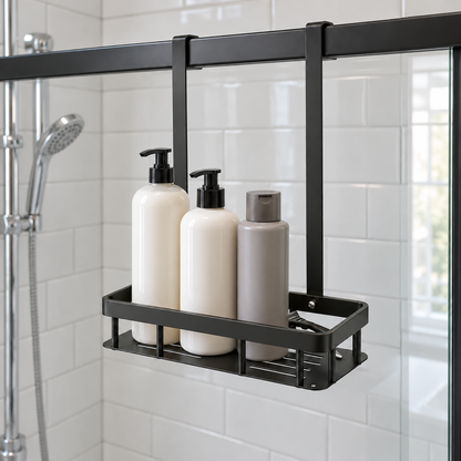 Black single-basket shower caddy hanging inside a white tiled shower from the top of the glass door, holding three bottles