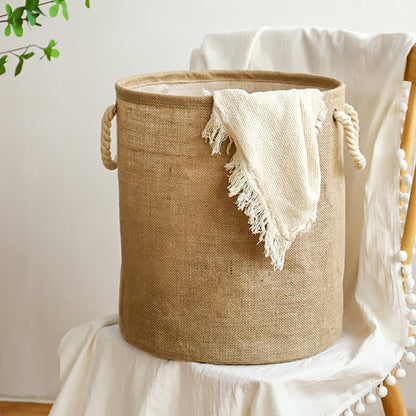 Cotton linen laundry basket on a chair with a cream fringed throw draped over the rim