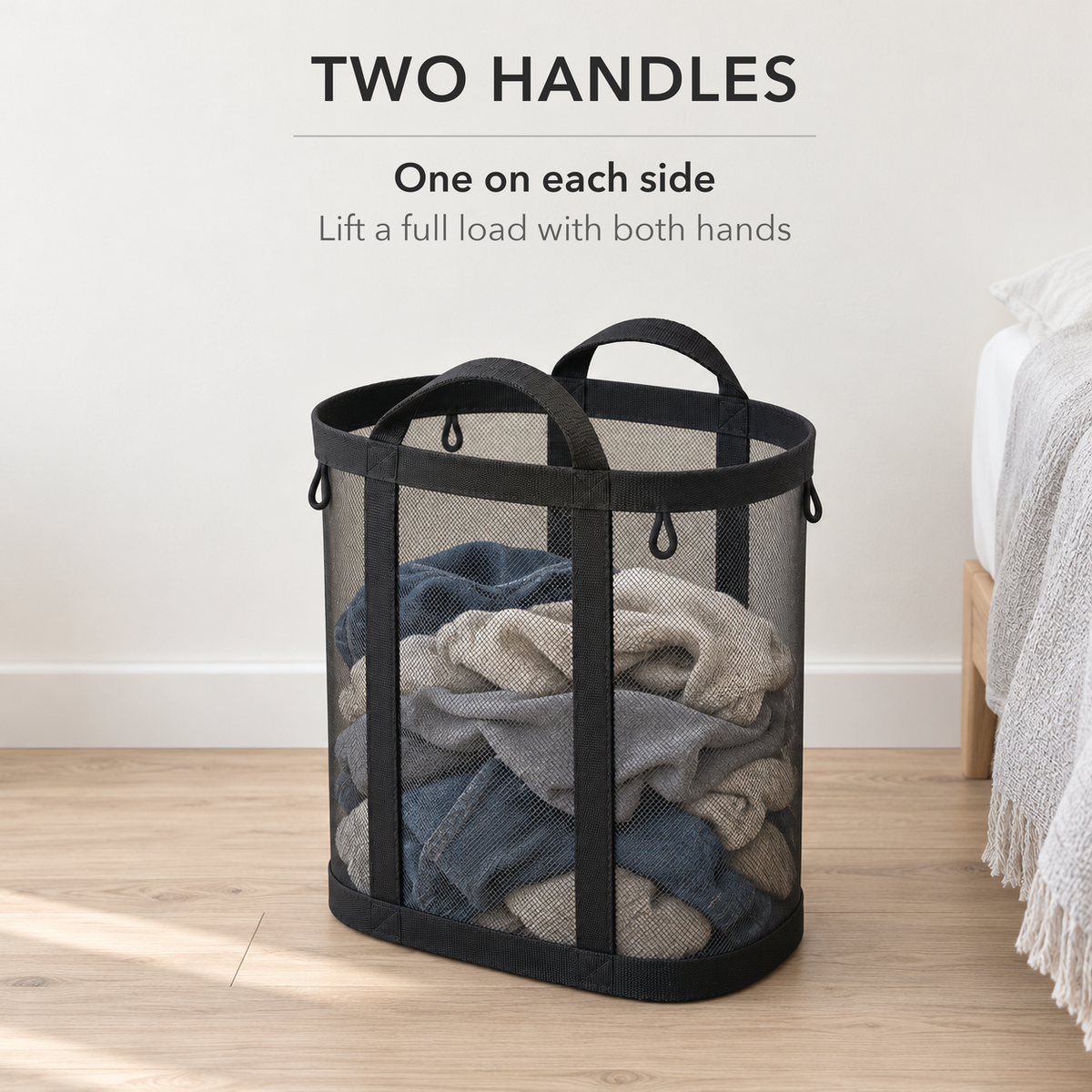 Black mesh laundry basket full of clothes with a handle on each side, text reads Two handles, one on each side