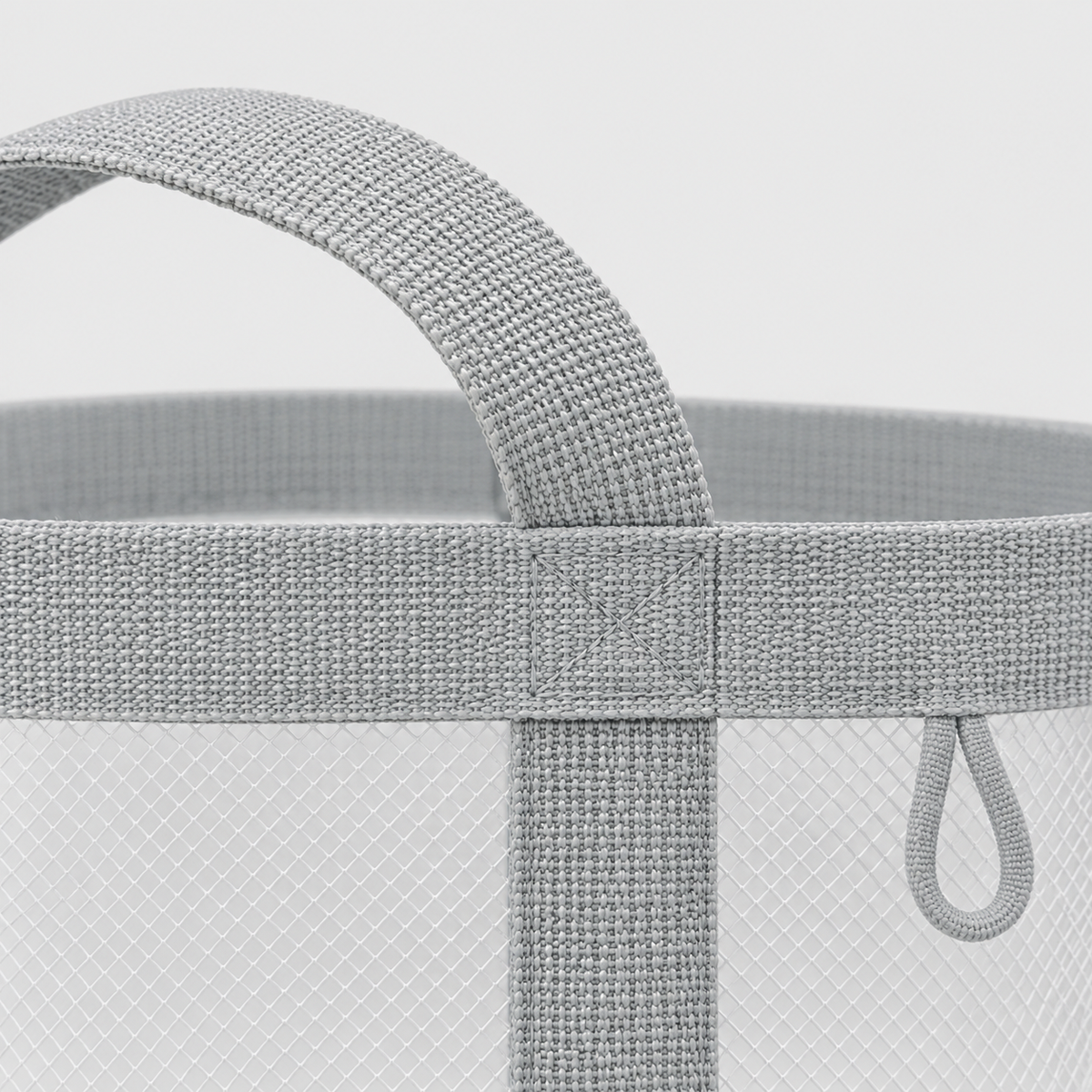 Close-up of the gray webbing handle stitched to the rim of the mesh laundry basket