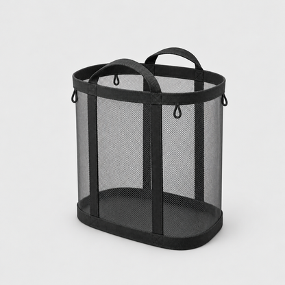 Black mesh laundry basket with two carry handles on a plain gray background