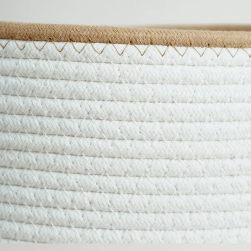 Macro of braided white cotton rope rows stitched together under a tan braided rim