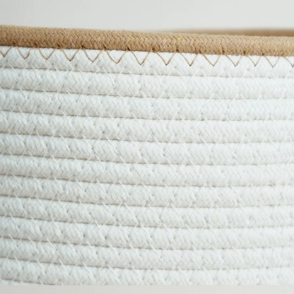 Macro of braided white cotton rope rows stitched together under a tan braided rim