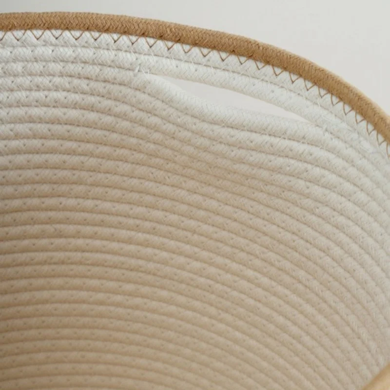 Inside the white rope basket, showing the hand slot just below the beige rim