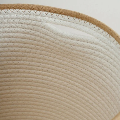Inside the white rope basket, showing the hand slot just below the beige rim