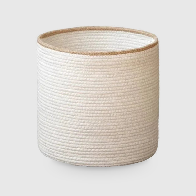 Large white rope basket with a beige rim, taller than it is wide, on a light gray background