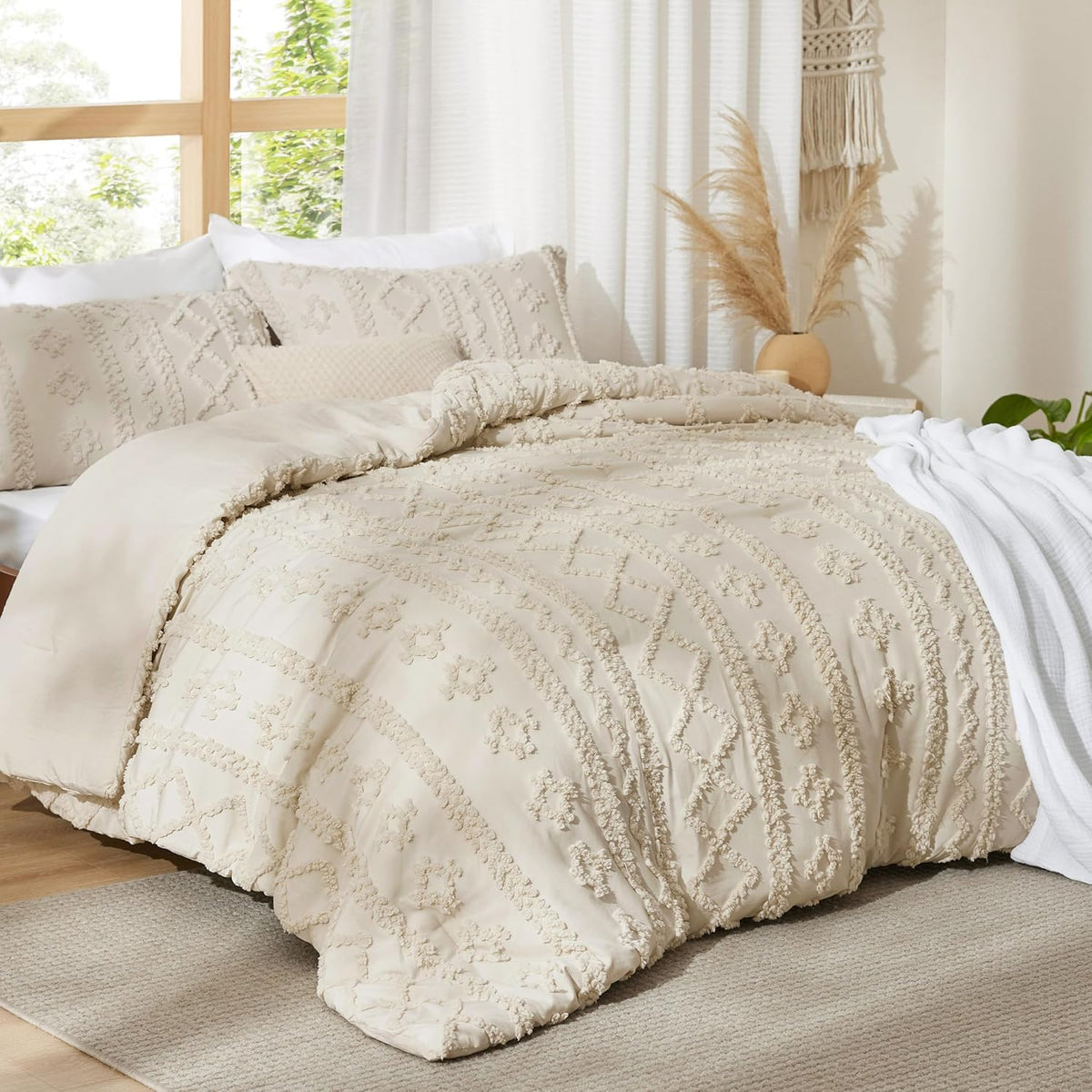 Beige duvet cover with raised boho stripes on a bed beside a window with pampas grass