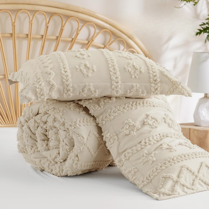 Tufted beige duvet cover rolled up beside its two matching pillow shams on a bed
