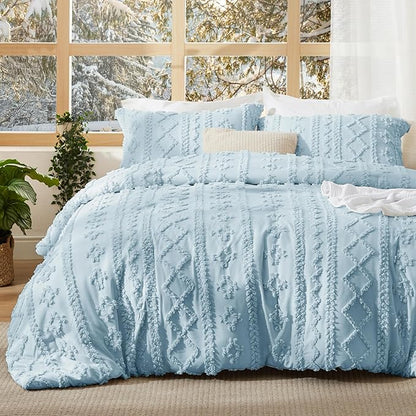 Light blue tufted duvet cover set with geometric stripes on a bed