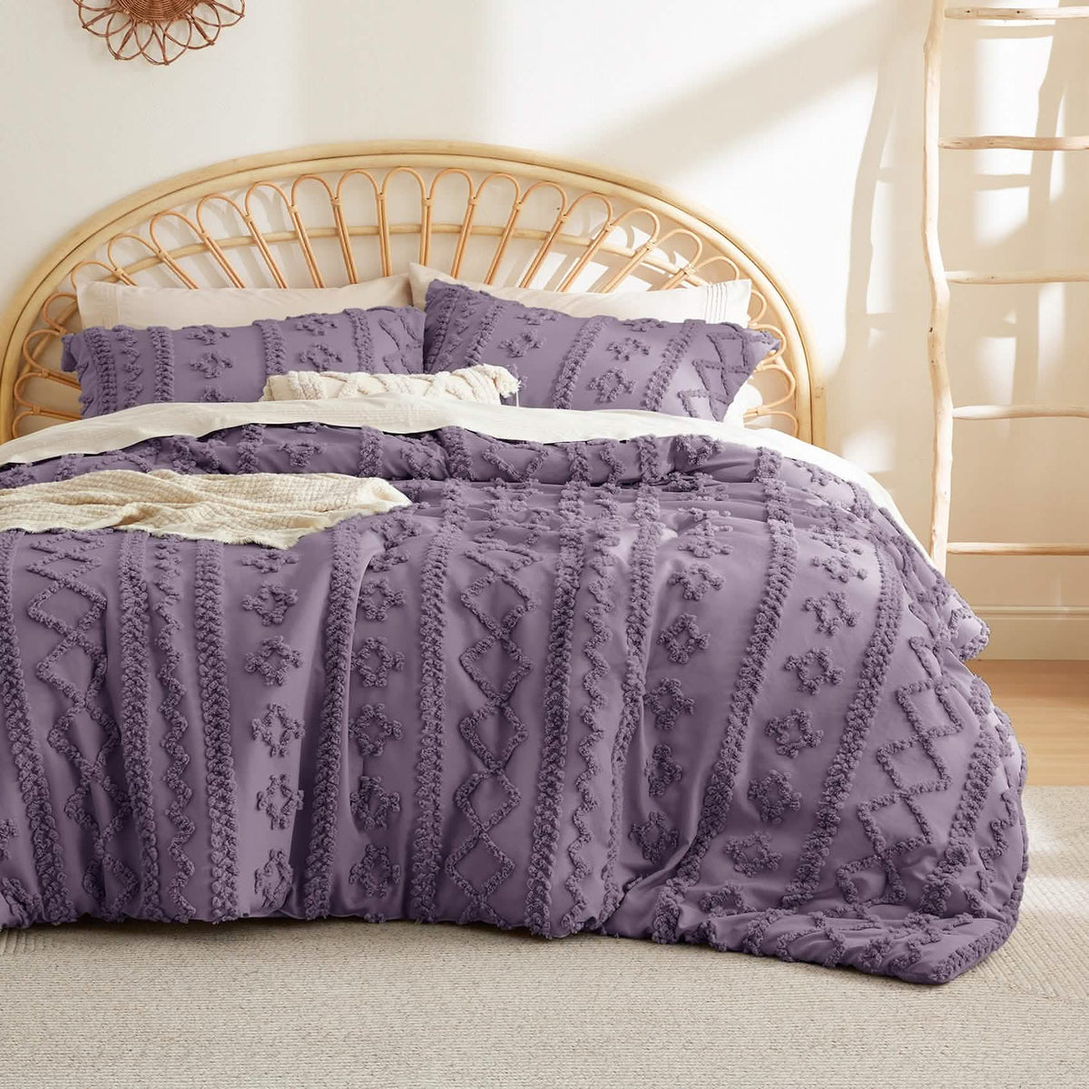 Purple tufted duvet cover set with matching pillow shams on a bed with a rattan headboard