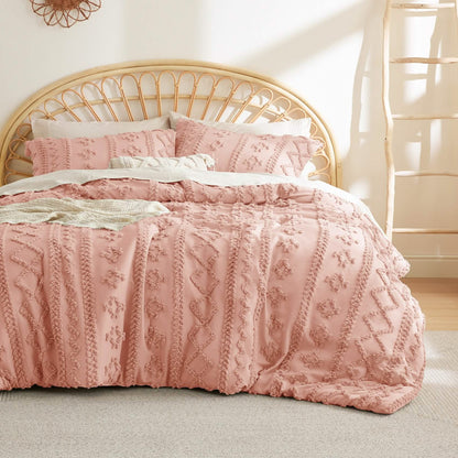 Pink tufted duvet cover set with raised boho stripes on a bed with a rattan headboard