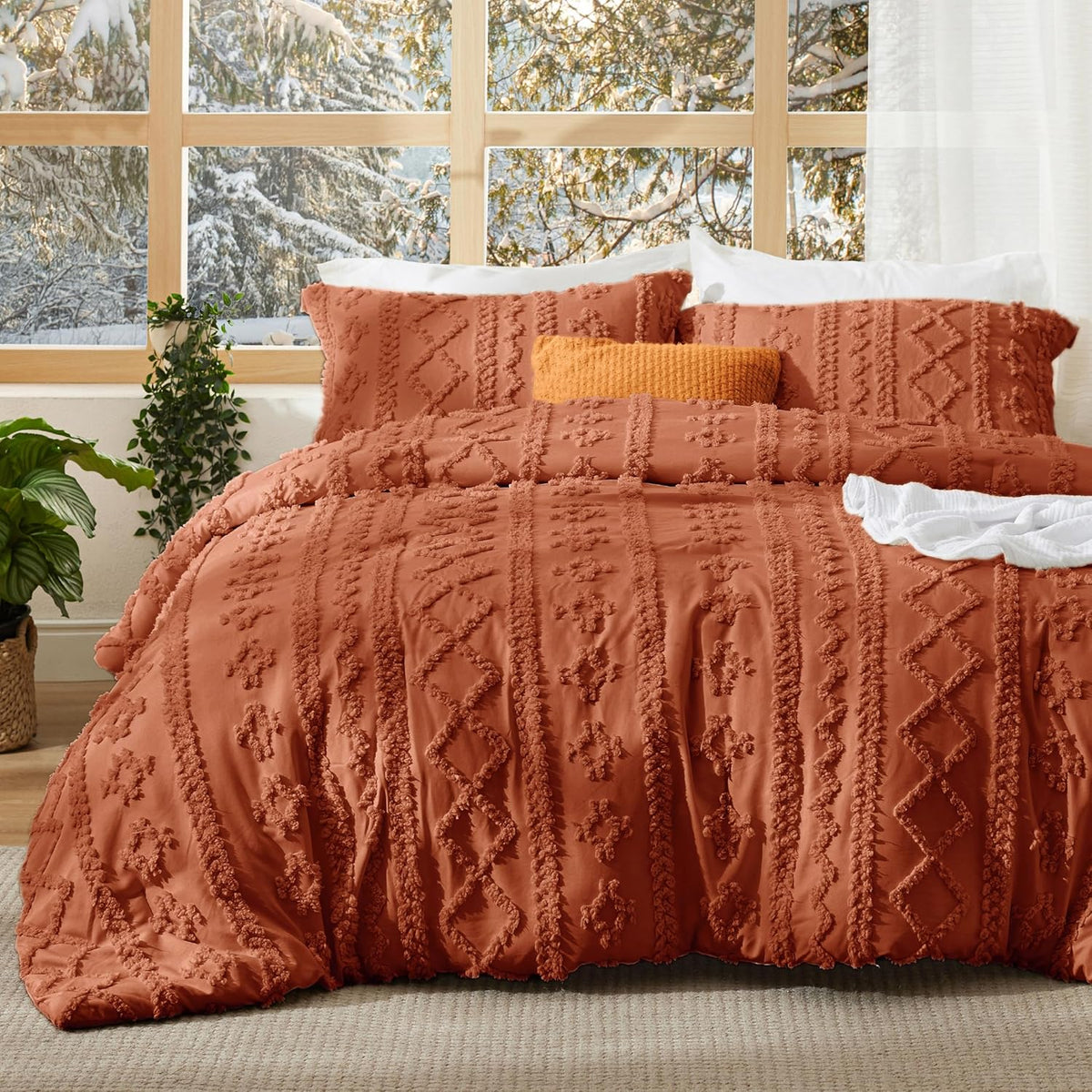 Rust terracotta tufted duvet cover set with two pillow shams on a bed by a window