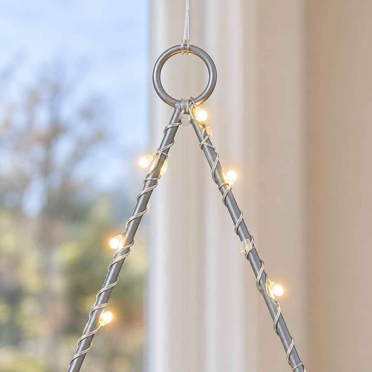 Close-up of the star light's top ring and slim frame with fine wire and tiny LED beads wound around it