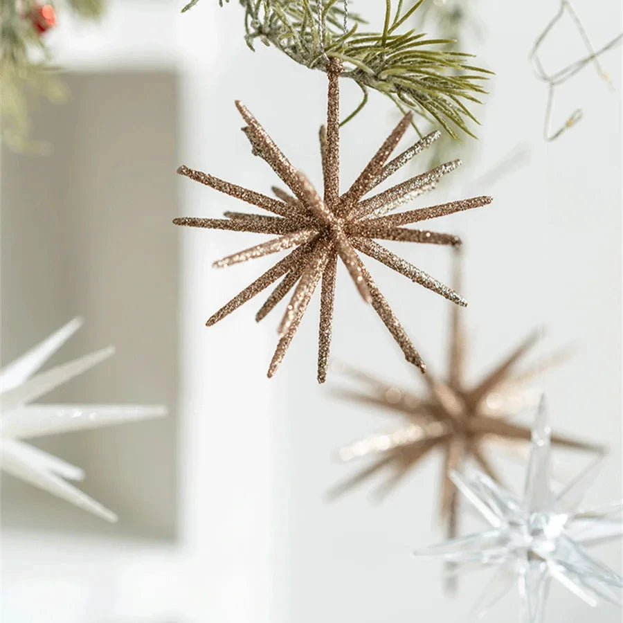 Champagne starburst and clear star ornaments hanging in front of white shelves