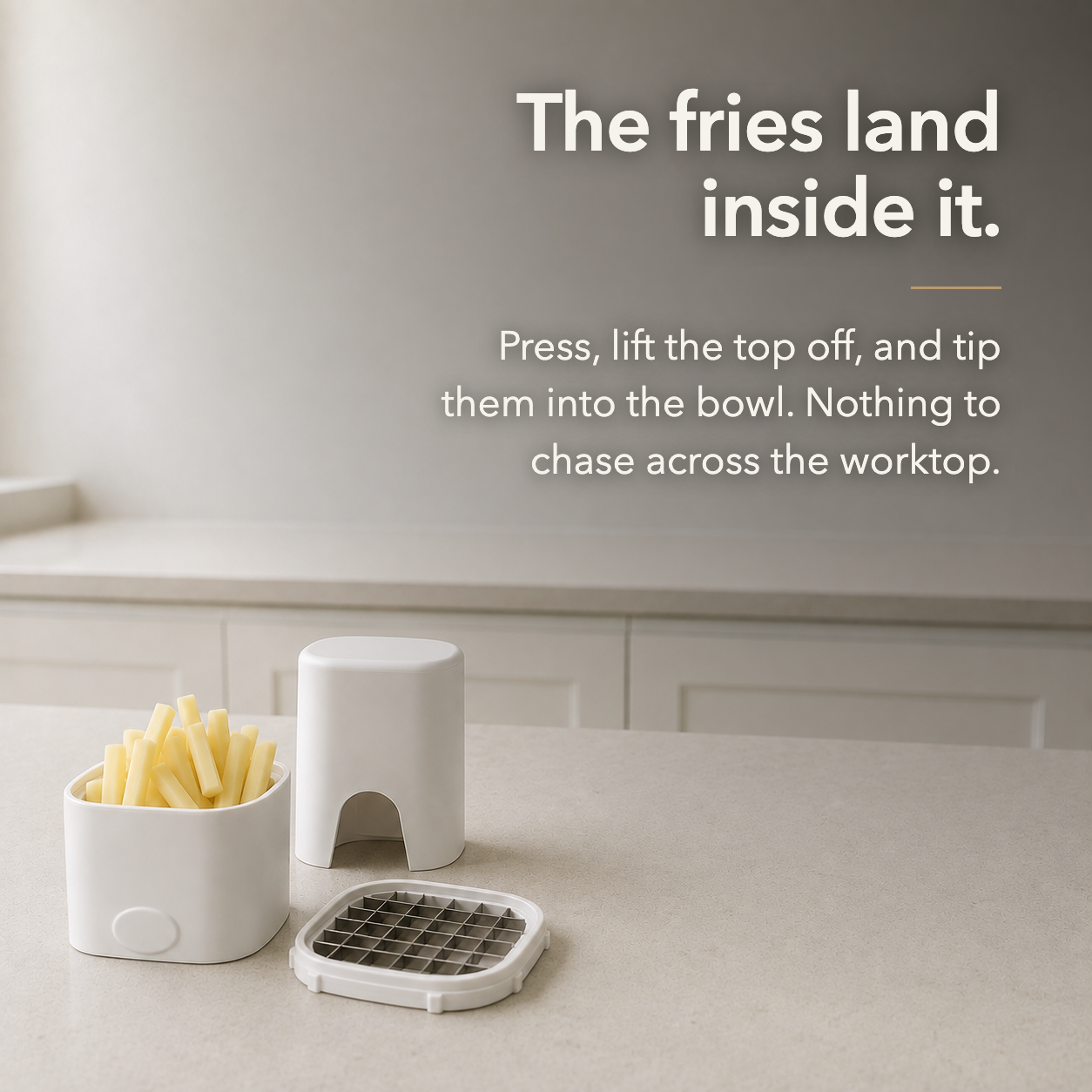 The base holding cut fries with the blade grid removed, captioned The fries land inside it
