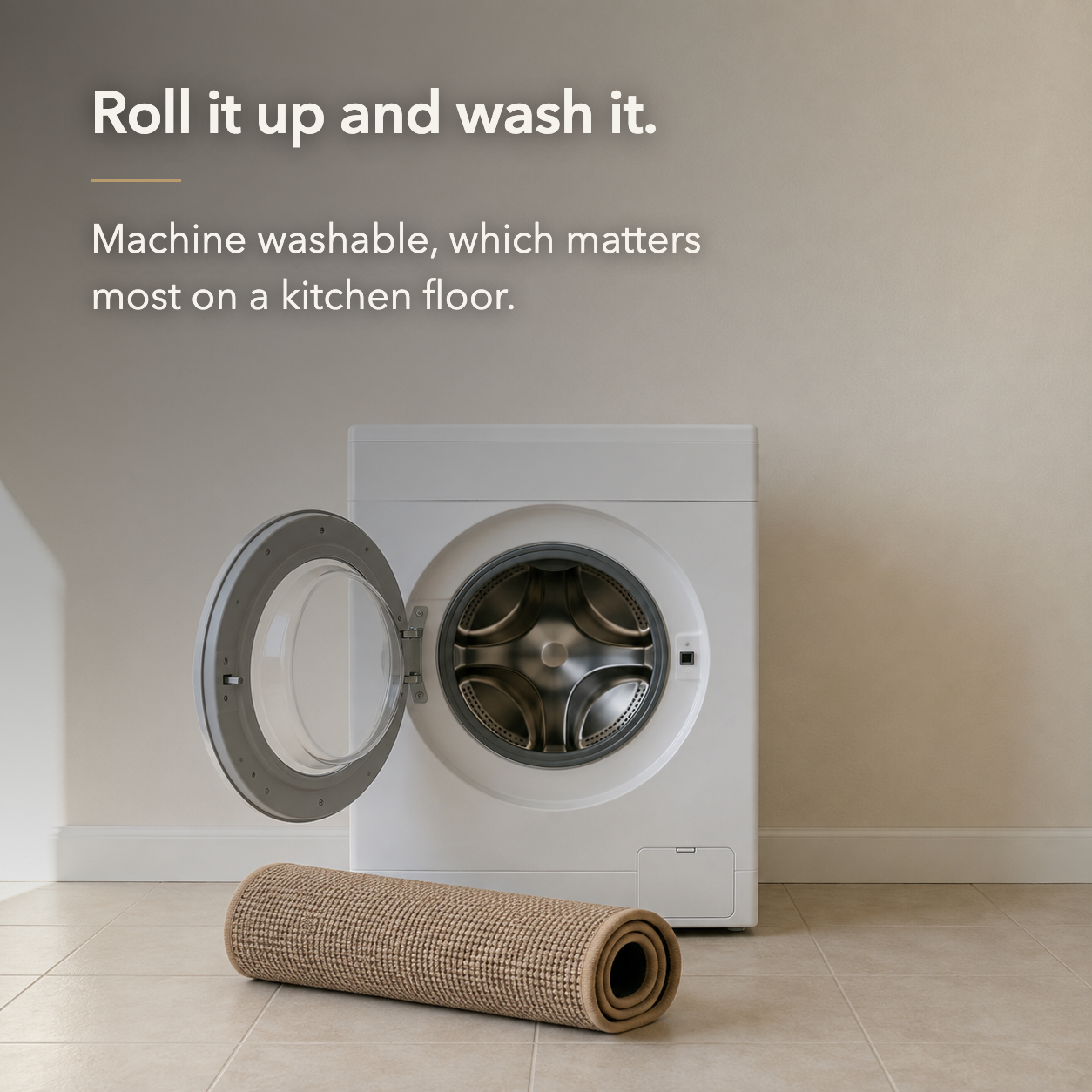 Beige woven kitchen rug rolled up on the floor in front of an open washing machine, showing it is machine washable