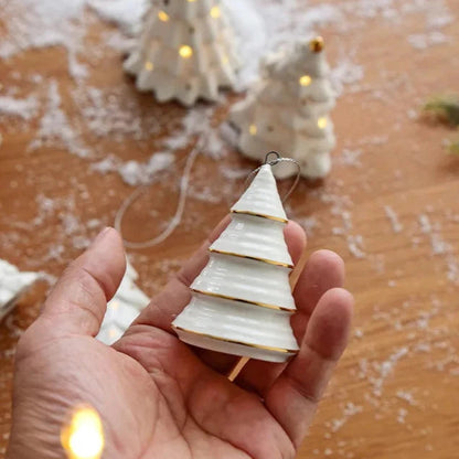 The Cone ceramic tree ornament held in an open hand, showing its small size