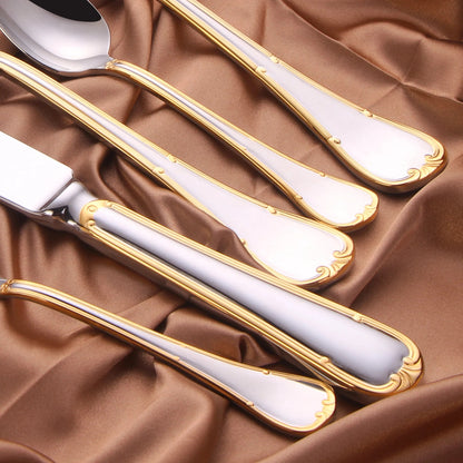 Close view of the handle ends: gold double-line border, raised beads and scroll tips on polished steel