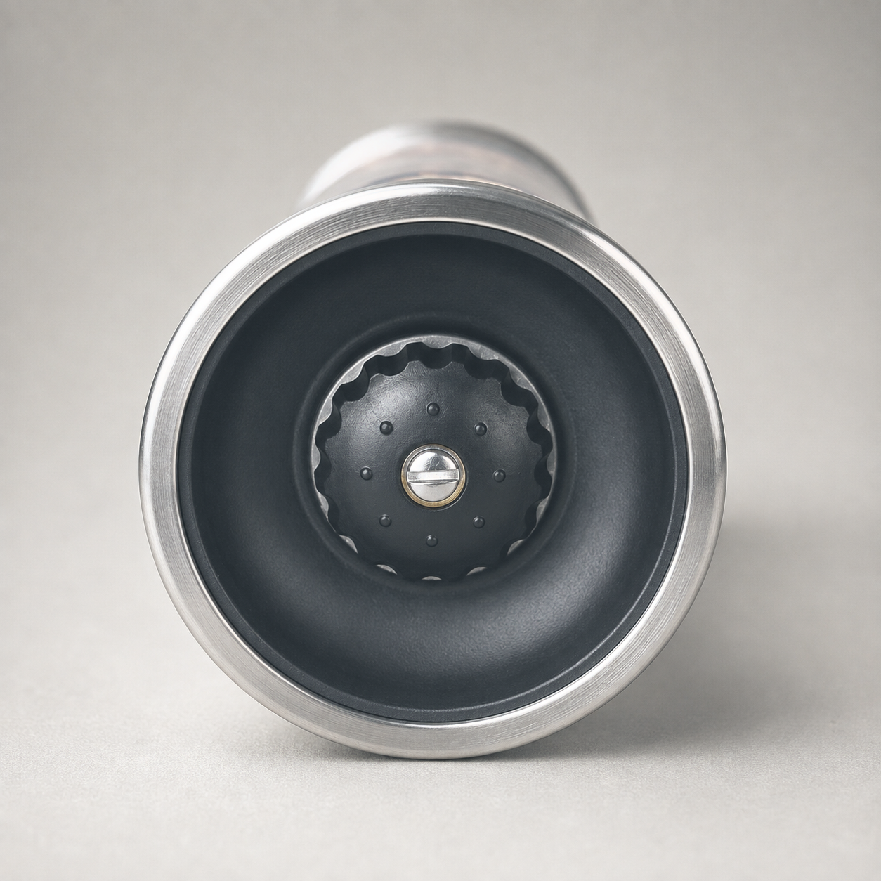 The ceramic grinding head and the central screw that sets the coarseness