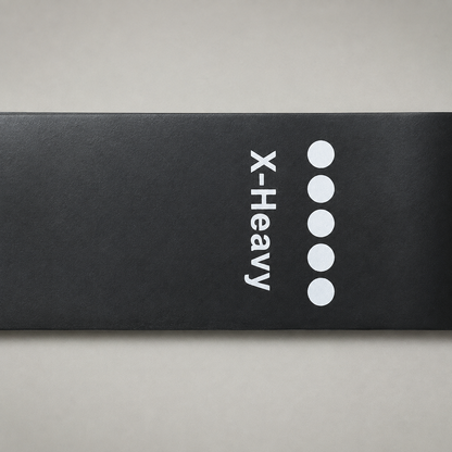 Close up of the X-Heavy marking printed across a band, with five filled circles beside the word