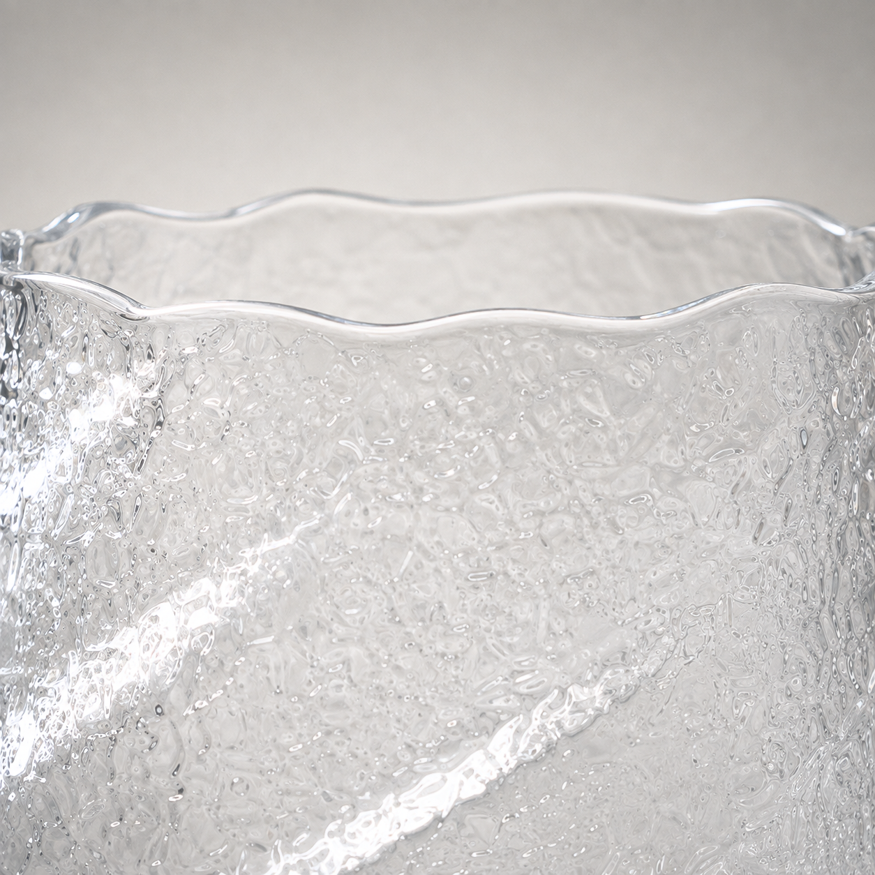 Close-up of the tumbler's uneven wavy rim and its dense hammered surface texture