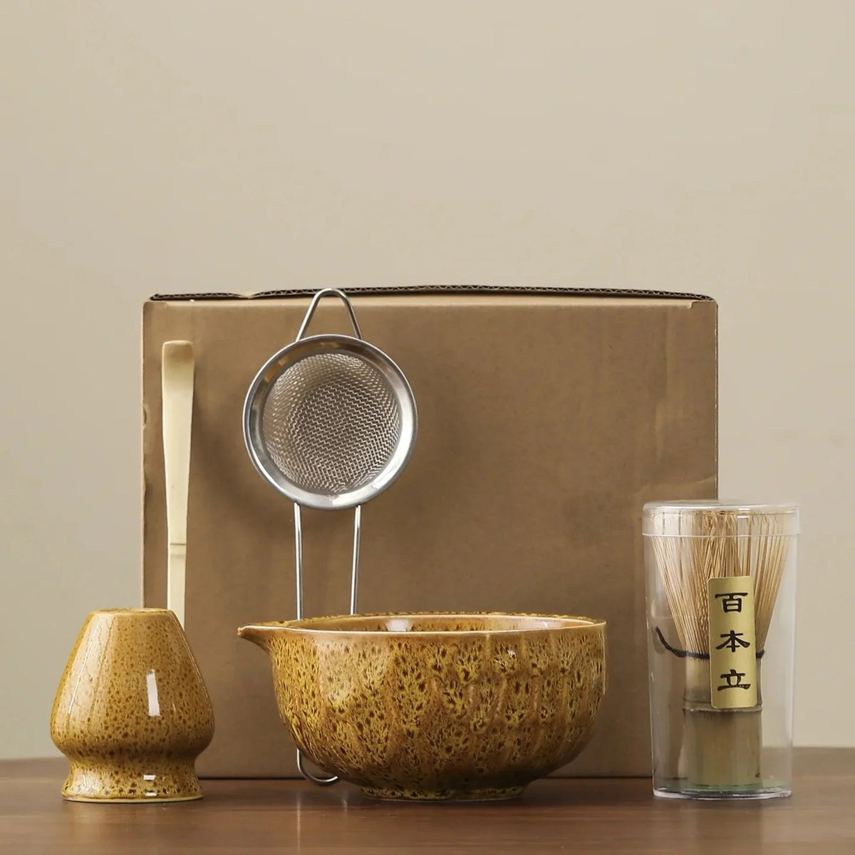 Yellow matcha set: whisk stand, bamboo scoop, steel sifter, spouted ceramic bowl and bamboo whisk in its clear tube