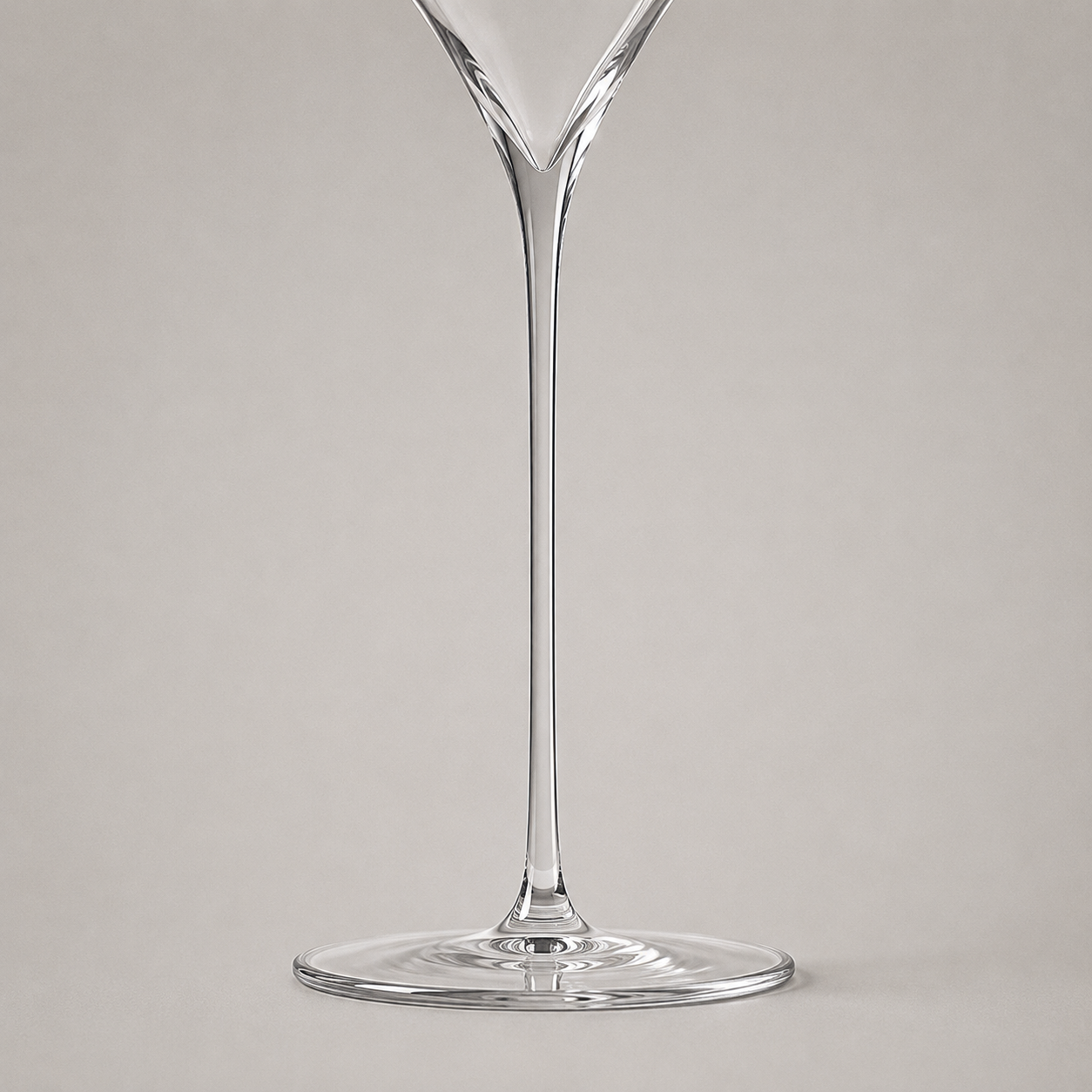 The fine stem drawn in one piece into the thin flat foot