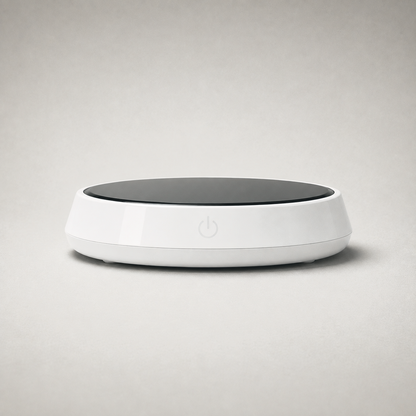 Mug warmer on plain grey, white body with a black glass top plate