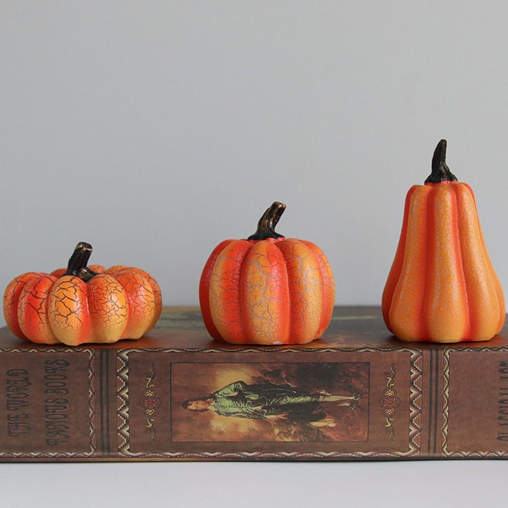 The tall gourd, medium pumpkin and short round pumpkin side by side
