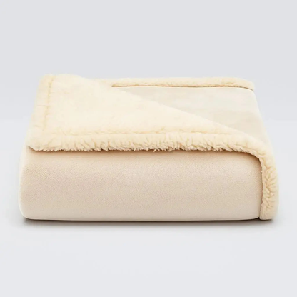 Beige waterproof blanket folded to show its plush face and paler cream sherpa reverse