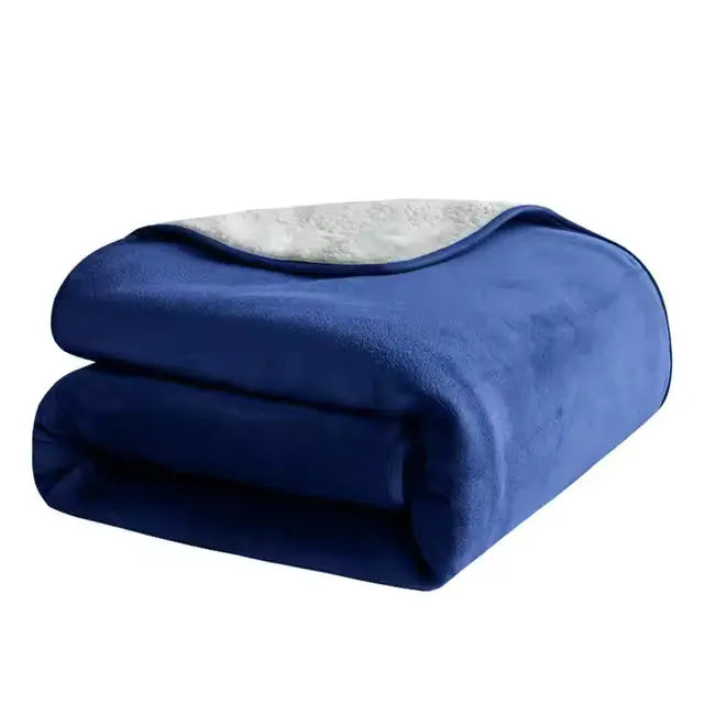 Blue waterproof pet blanket folded on a white background, the pale fleece reverse turned back on top