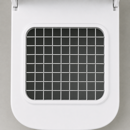 Close-up of the stainless steel blade grid set into the white top deck, an even lattice of square cells with dark openings.