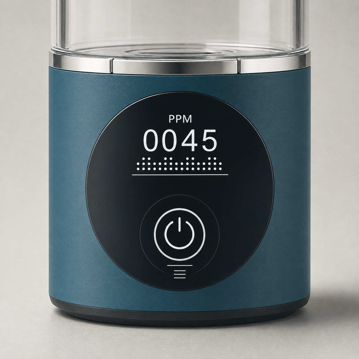 Macro of the round black panel on the base, reading PPM 0045 above a dotted bar, with the power touch button below