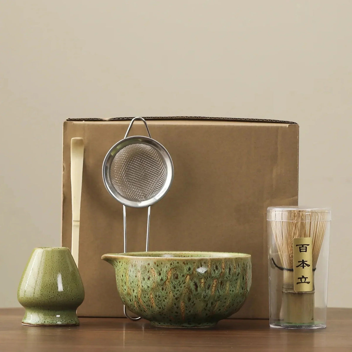 Green matcha set: whisk stand, bamboo scoop, steel sifter, spouted ceramic bowl and bamboo whisk in its clear tube